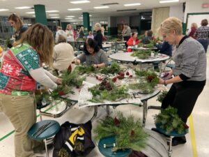 Folks working at a wreath making class by wild wind farm and florist at dirt farm brewing