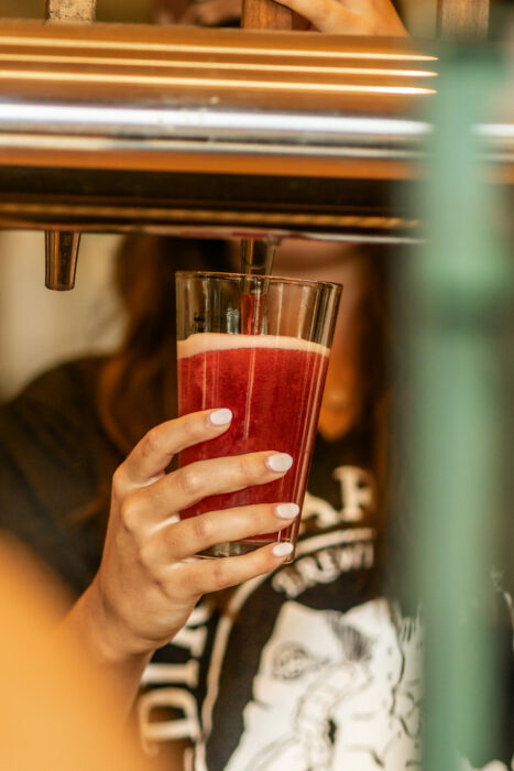bartender pouring a beer during happy hour or steal the Pint night at dirt farm brewing in Loudoun county virginia