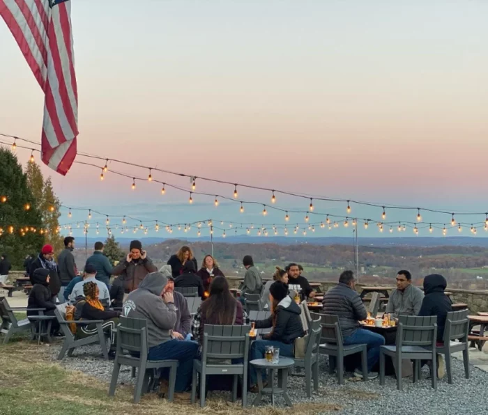 Guests sitting outdoors at Dirt Farm Brewing enjoying the sunset and a loudoun county beer