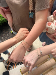 Guests showing off their new permanent Jewelry at Dirt farm brewing