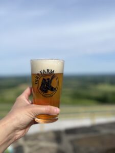 a guest raising a pint to our local first responders during first responders Days at dirt Farm Brewing in Bluemont virginia