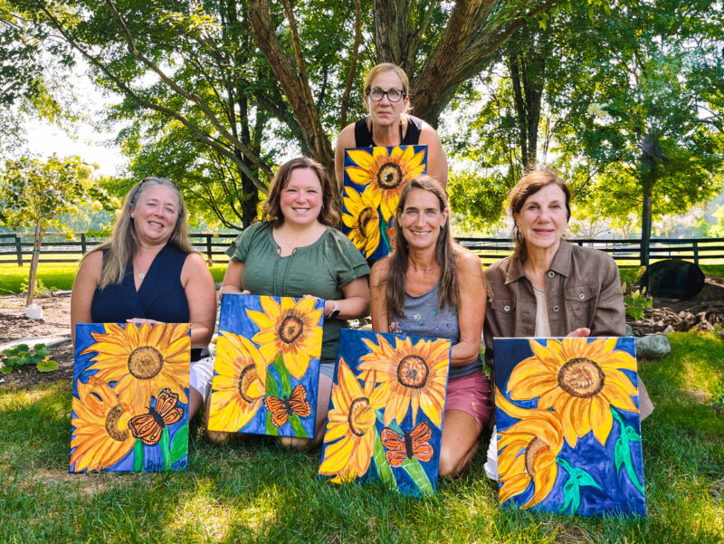 Guests showing off their art work after a paint and sip event at Dirt Farm Brewing in Bluemont virginia
