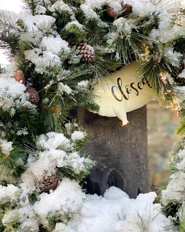 snowy wreath hanging at dirt farm with a closed sign in Loudoun county