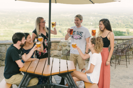 Guests at Dirt Farm Brewing enjoying a beer on the patio to celebrate their event.