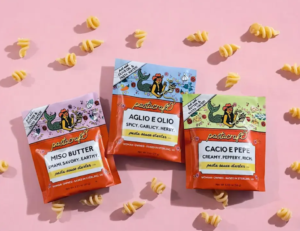 Pastacraft Pasta sauce starter packets displayed with pasta