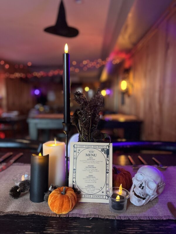Halloween Beer dinner tablescape with skulls, black candles and miniature pumpkins at dirt farm brewing in Loudoun county virginia