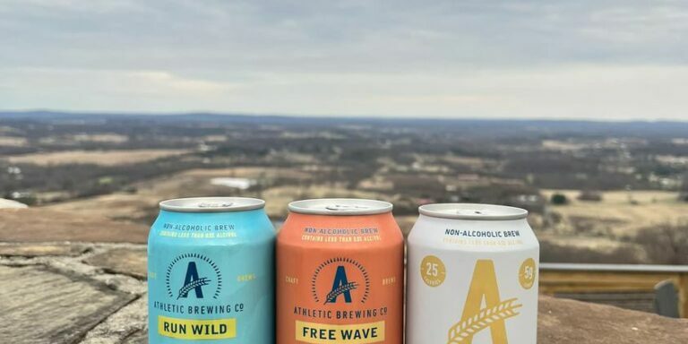 323884560_691229075999713_1616779993363876280_n (1) Athletic Brewing Company NA beer sitting in front of view at dirt farm brewing