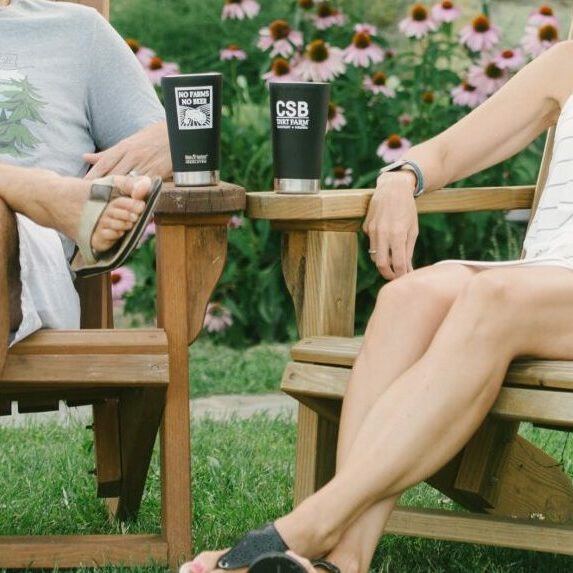 CSB Members Enjoy a Pint in Adirondack Chairs on the Patio