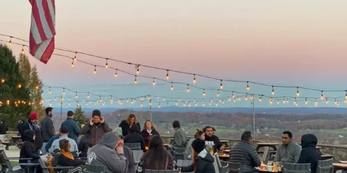 Guests sitting outdoors at Dirt Farm Brewing enjoying the sunset and a loudoun county beer